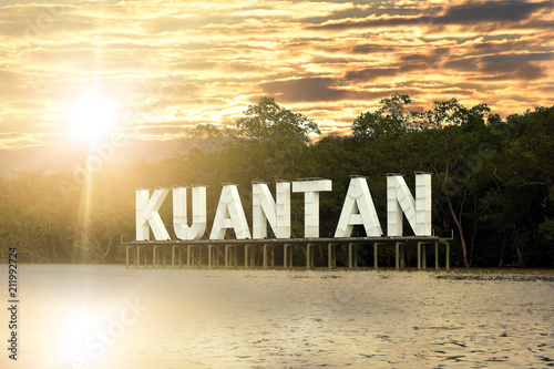 Kuantan sign on river in Kuatan, Phahang, Malaysia - River water with reflection while sunset photo