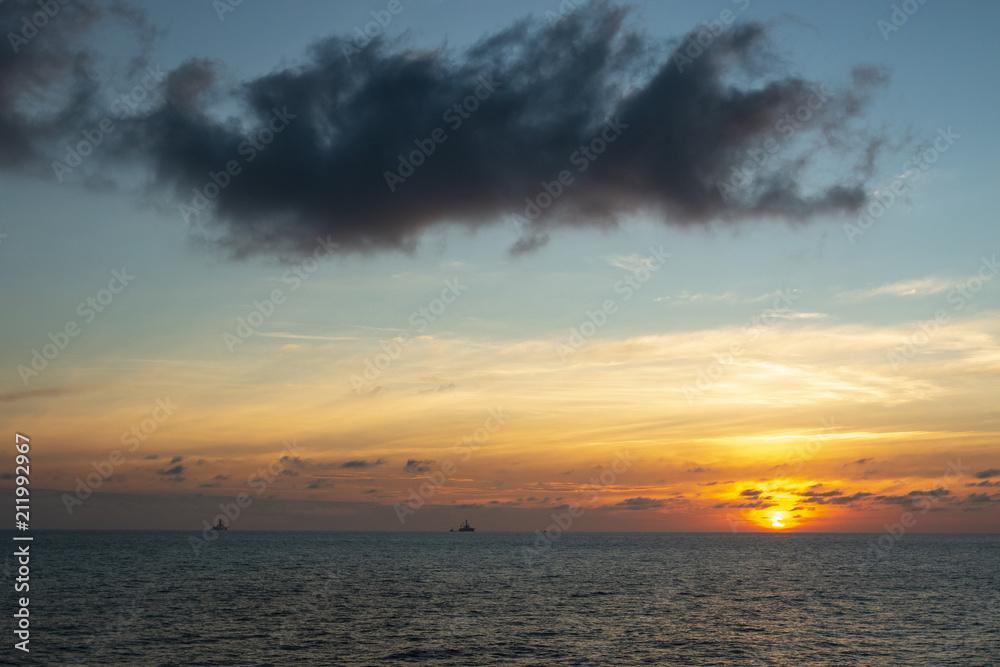 Sunrise over the oil towers and offshore oil rigs 