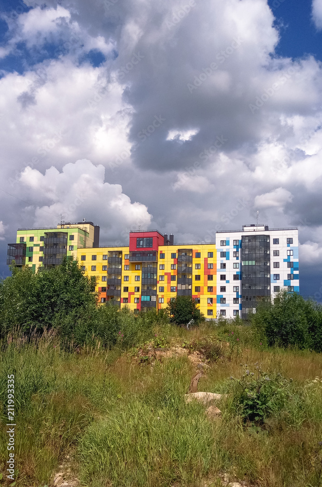 Modern beautiful new buildings. Colored wall on the background of blue sky. Modern beautiful new buildings. Colored wall on the background of blue sky.