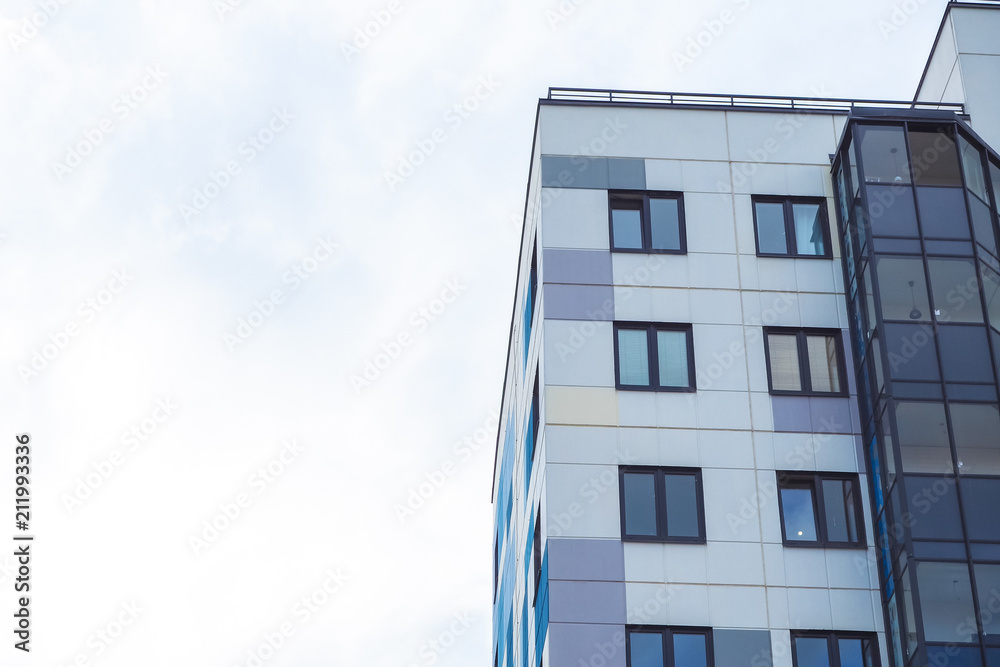 Modern beautiful new buildings. Colored wall on the background of blue sky. Modern beautiful new buildings. Colored wall on the background of blue sky.