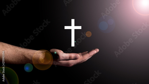 Male hand showing the cross, concept of the religion of Christianity
