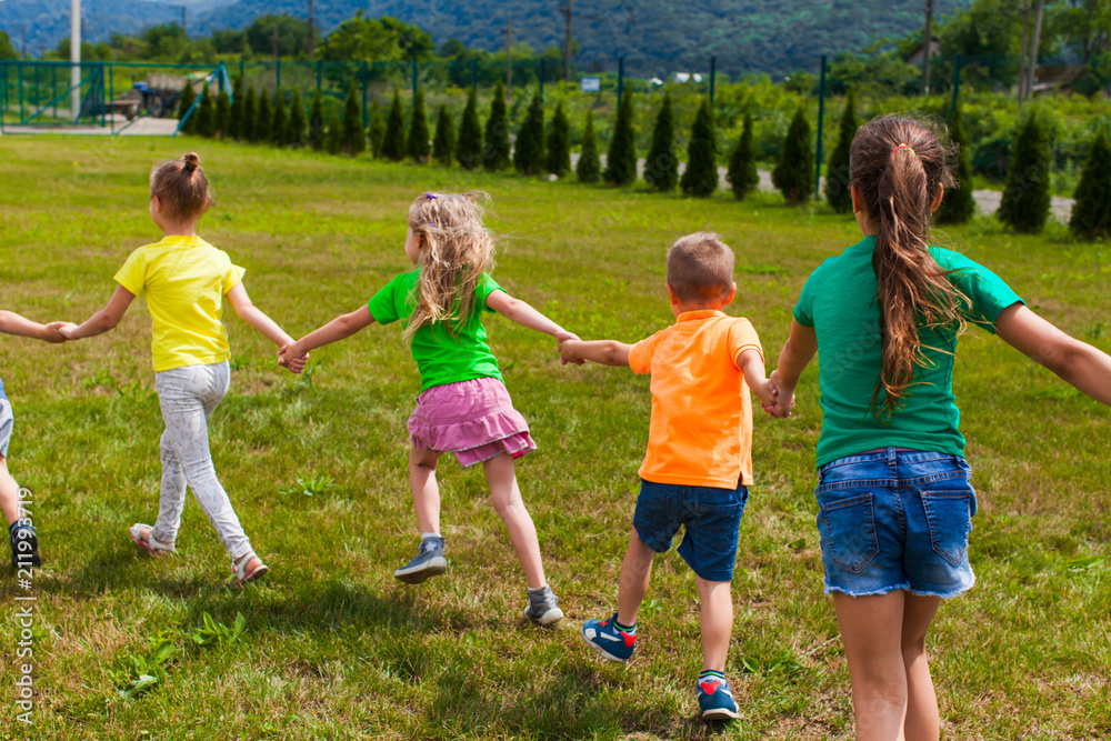 Group of children in colorful t-shirts on their holidays Group of children in colorful t-shirts on their holidays
