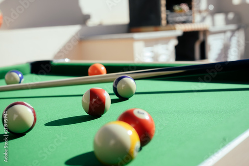 Pool colorful balls on the table sunshine outdoors backgroud. Close up view photo of leisure luxury lifestyle poolgame photo