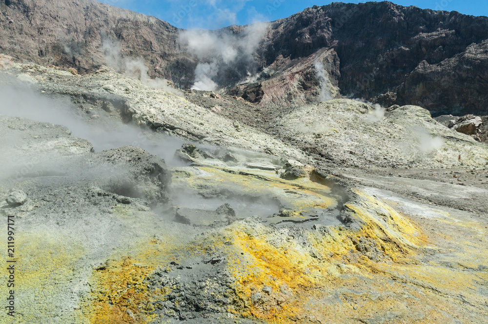 Thermal activity in the crater of the active volcano of White Island, Whakaari, off the Bay of Plenty coast, New Zealand. Yellow crystals of sulphur in the foreground.