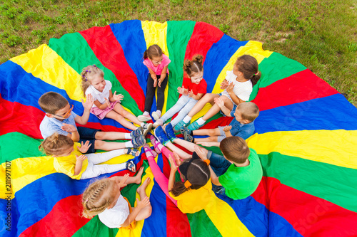 Kids holding hands together with teacher in gym photo