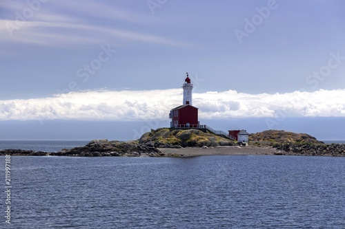 Fisgard Lighthouse, Canadian National Historic Site, and Distant Cloudscape over Juan De Fuca Strait near Victoria, British Columbia photo