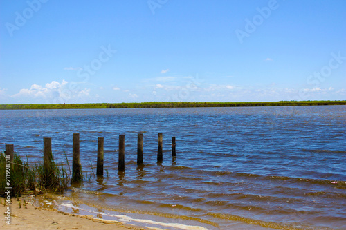 River with Wooden Posts from Broken Pier