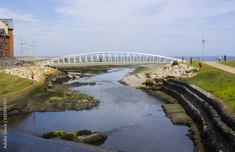 The modern footbridge at the mouth of the Shimna River on the seafront in Newcastle County Down Northern Ireland