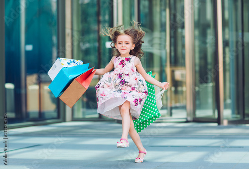 Cute little girl on shopping. Portrait of a kid with shopping bags. Shopping. girl.