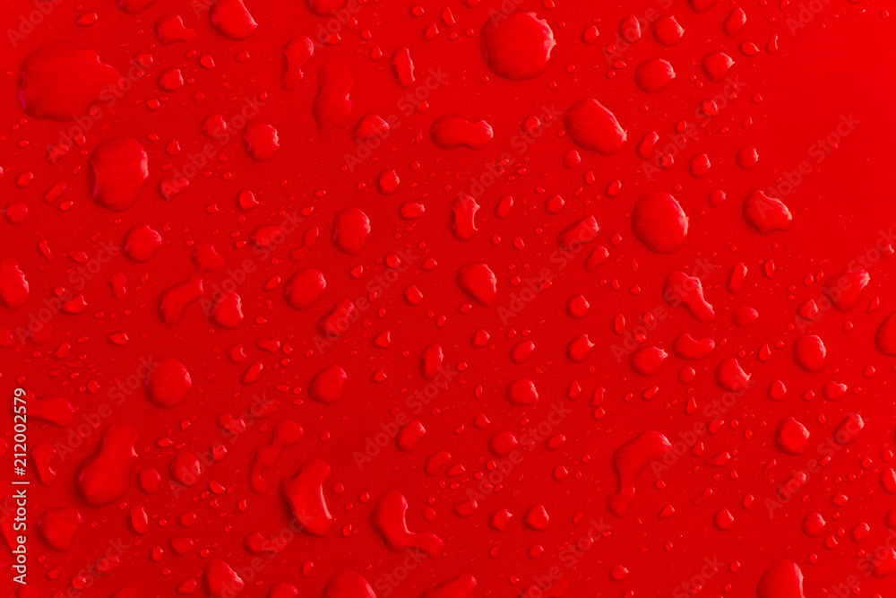 Red water droplet on the roof of car Red water droplet on the roof of car