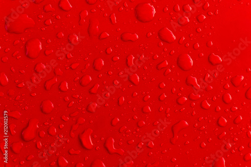 Red water droplet on the roof of car