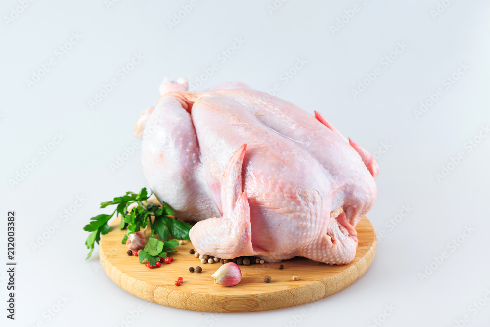raw chicken carcass on the cutting board isolated on white background raw chicken carcass on the cutting board isolated on white background