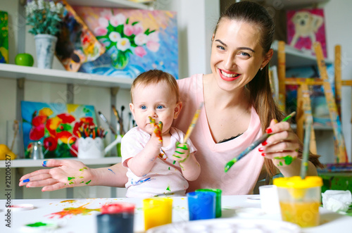 Mom and Daughter paint on canvas at the drawing school.