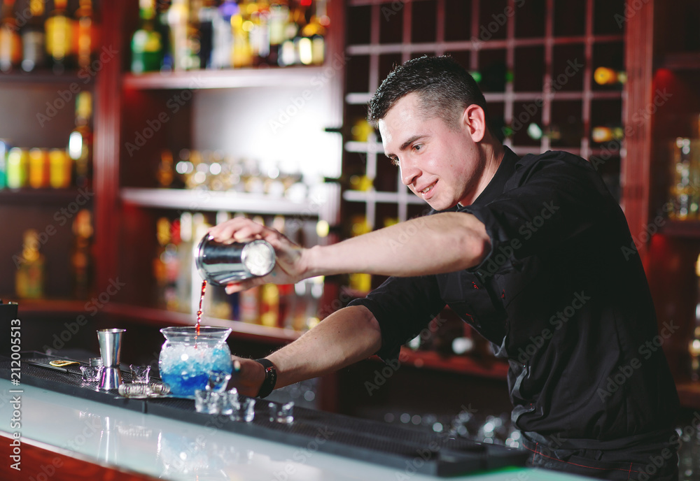 Bartender pouring fresh cocktail in fancy glass Bartender pouring fresh cocktail in fancy glass