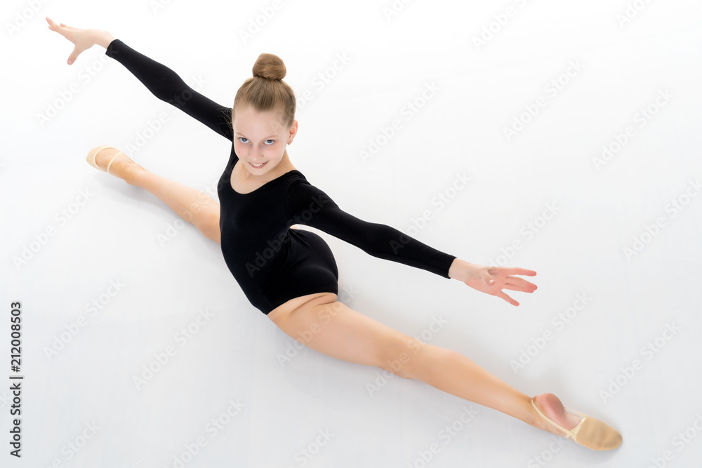 Girl gymnast perform the twine exercise. Girl gymnast perform the twine exercise.