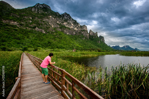 The wooden bridge overlooking the scenery at Sam Roi Yod National Park. It is beautiful and surrounded by nature in Prachuap Khiri Khan, Thailand. © bangprik