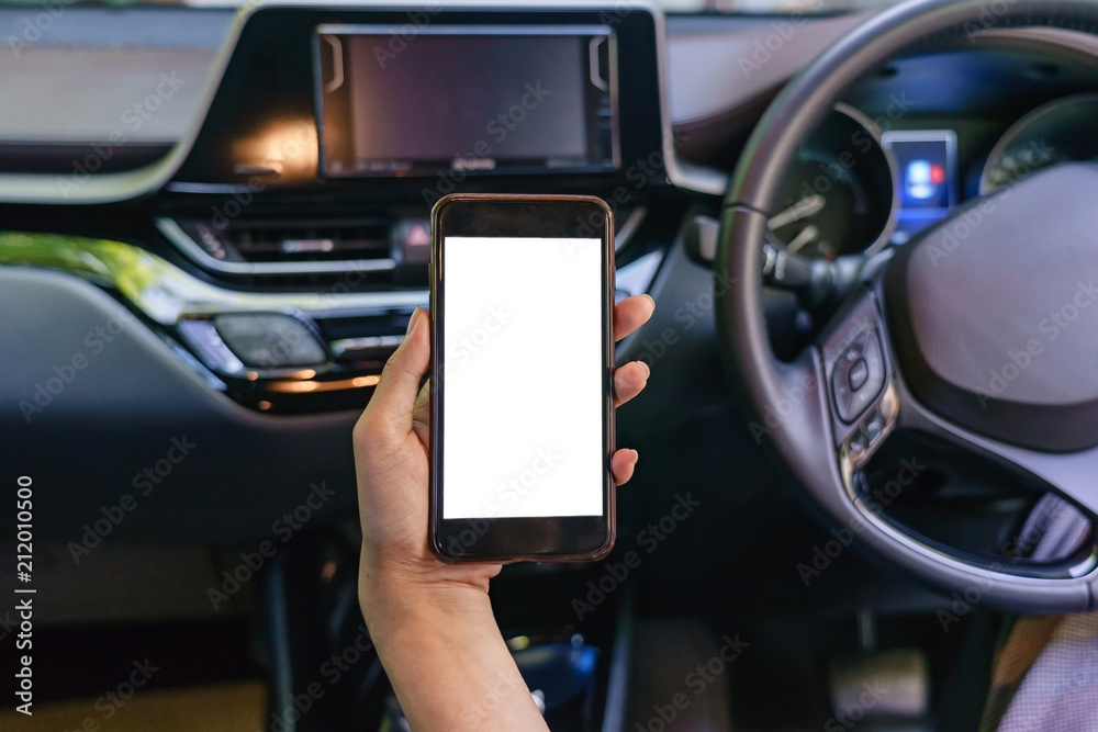 Front view of modern smartphone with blank screen with copy space for your text or design, close-up of female driver hands using mobile phone in a car