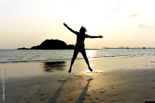 women jump on the beach