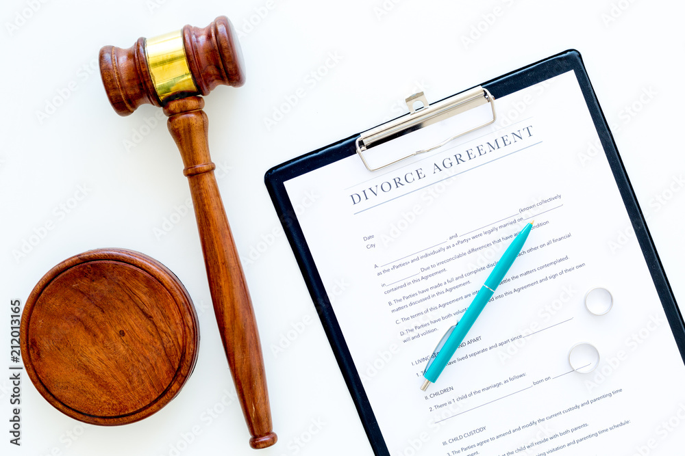 Divorce court case. Divorce agreement near wedding rings and judge gavel on white background top view