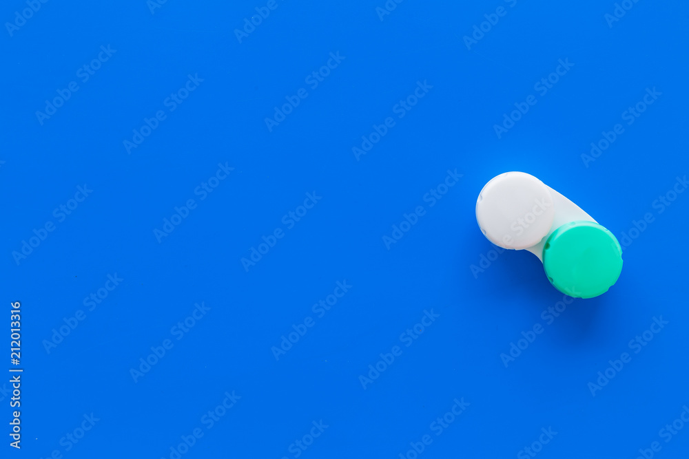 Contact lenses in container on blue background top view copy space Contact lenses in container on blue background top view copy space