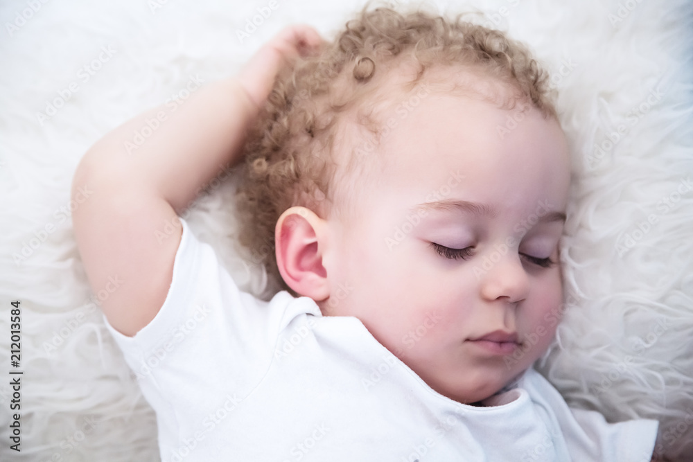 Sleeping one year old baby boy with blond curls Sleeping one year old baby boy with blond curls