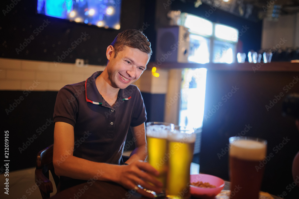 Man in the bar with two beers Man in the bar with two beers