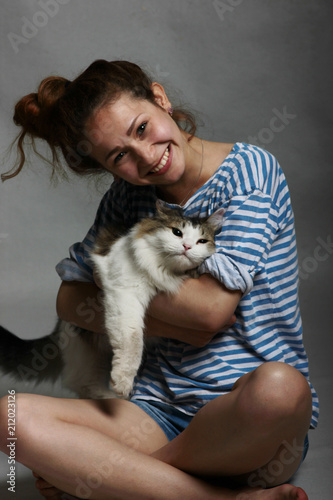 a young girl with a fluffy cat