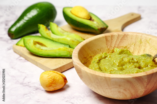 Guacamole sauce with avocado on marble table