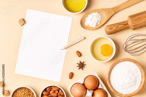 Ingredients and utensils for baking on a pastel background.