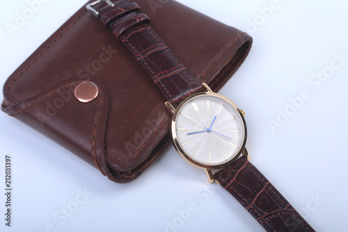 Men's accessories for business and rekreation. Leather wallet, watch and smoking pipe on white background.. Top view composition.