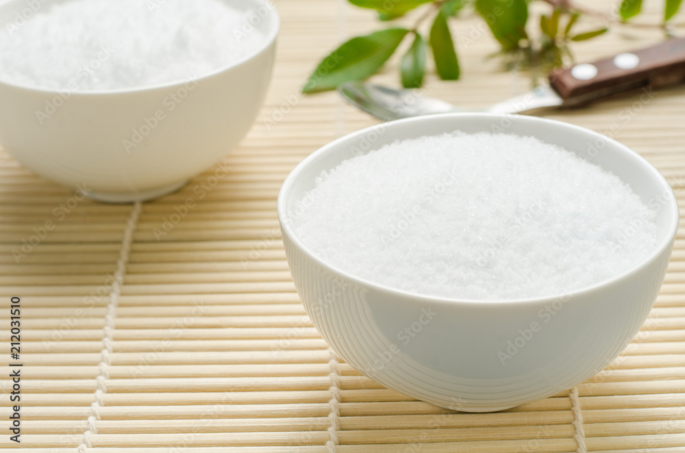 Salt in a white bowl on bamboo background. Salt in a white bowl on bamboo background.