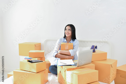 Sme business concept. Young people are packing their packages.Delivery business Small and Medium Enterprise (SMEs). Young woman is working in the house.Young Owner Start up for Business Online.