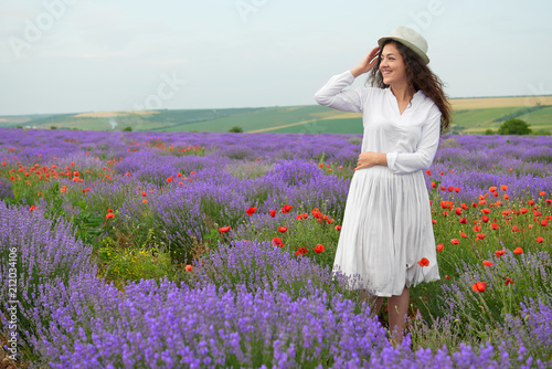 young girl is in the lavender field, beautiful summer landscape with flowers