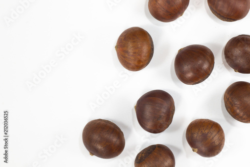 Chestnut , roasted beans brown color on white background .