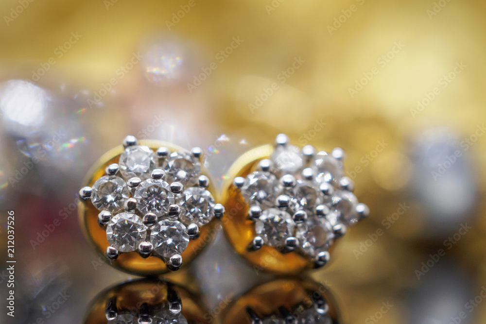 Luxury gold Jewelry diamond earrings with reflection on black background Luxury gold Jewelry diamond earrings with reflection on black background