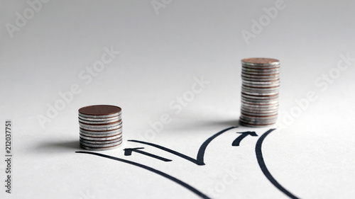 Two paths with different heights of coins. photo