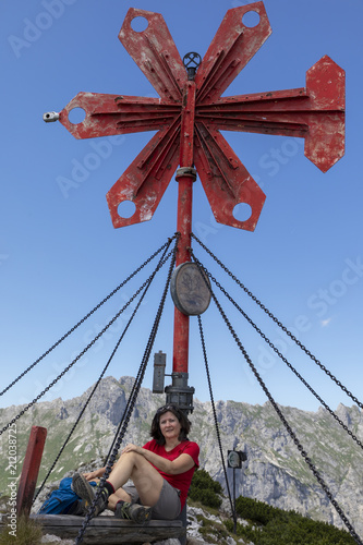 woman on the summit of leobner mauer, peak in the mountain range hochschwab, styria,austria photo