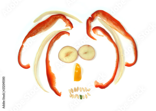 Rasta man face made with various raw vegetables, an emoticon on white background photo