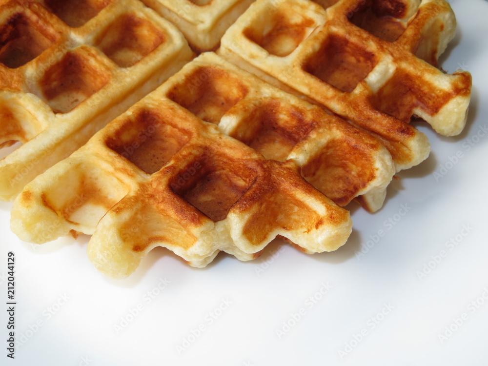 Belgian waffle isolated on white plate. Homemade breakfast Belgian waffle isolated on white plate. Homemade breakfast