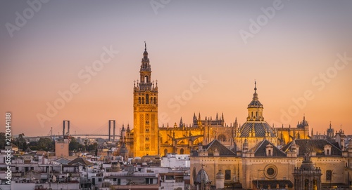 View of La Giralda and Iglesia del Salvador at sunset, bell tower of the Cathedral of Seville, Catedral de Santa Maria de la Sede, Seville, Andalusia, Spain, Europe photo