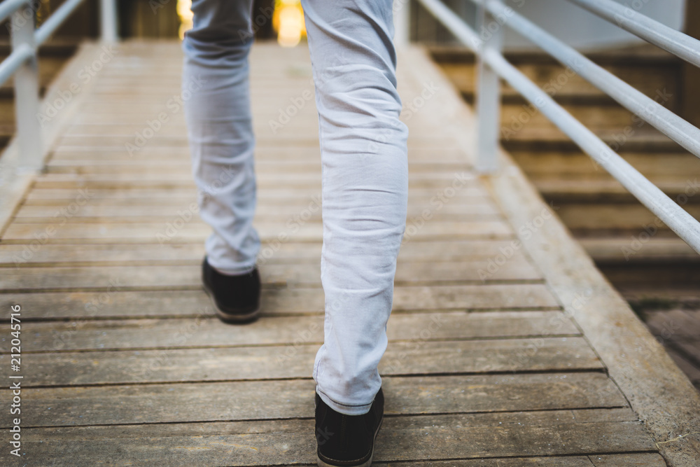 low section of a man walking up stairs