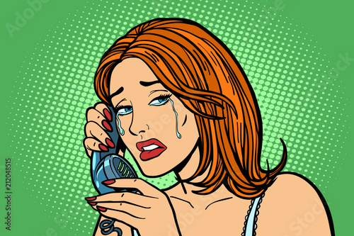 tearful Woman talking on the phone. Emotions.