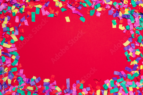 Festive party decor and confetti on pink background