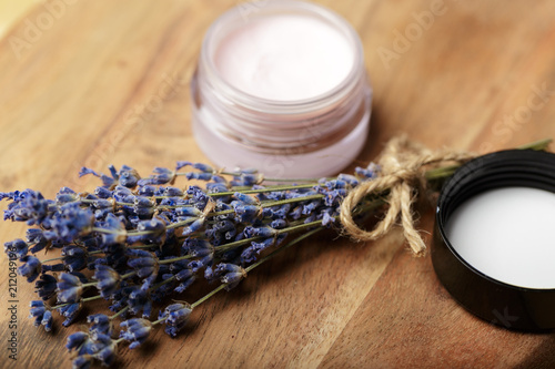 Bunch of lavender and cosmetic pot on a wooden table © fotofabrika