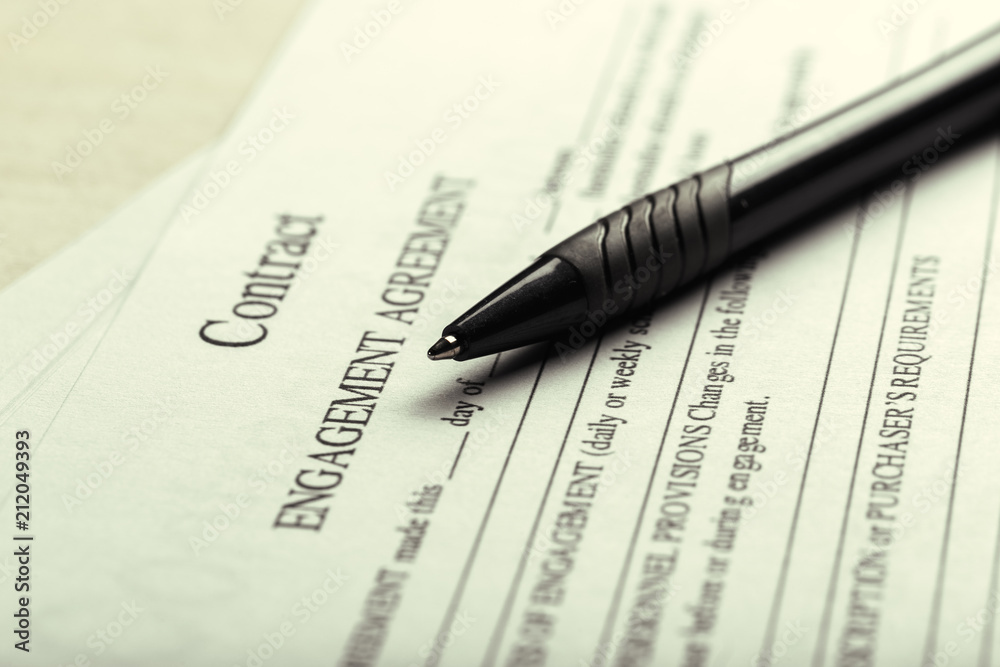 Obraz premium Close up shot of Eyeglasses on contract document papers business concept