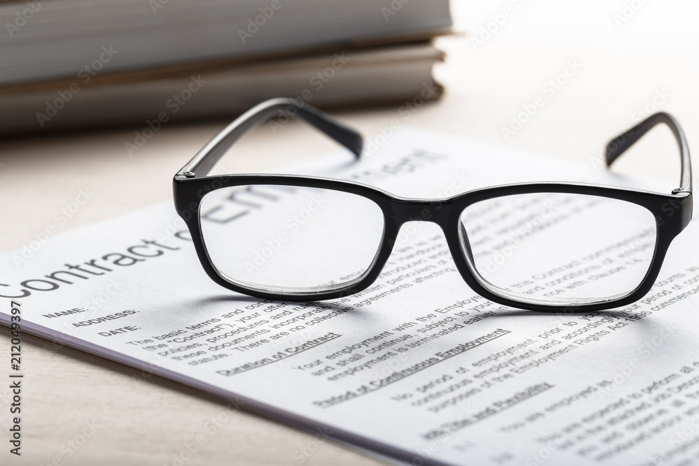 Close up shot of Eyeglasses on document papers business concept Close up shot of Eyeglasses on document papers business concept