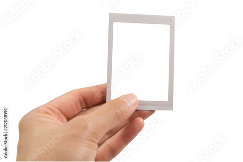 Hand holding instant photo or picture frame isolated on white background with clipping path.