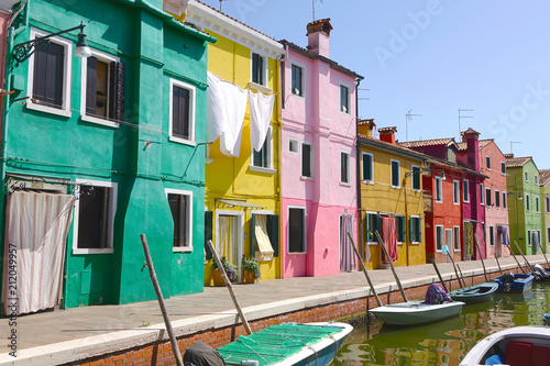 Walking along a calm river canal surrounded by picturesque colorful houses. © helivideo