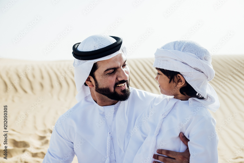 Naklejka premium father and son spending time in the desert