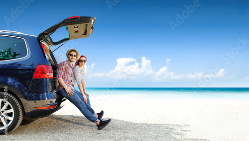 Summer trip on beach. Big blue car with two people. Free space for your text. 